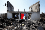 A Chilean flag is seen on a house in Valparaiso, Chile, Dec. 26, 2019, after it was destroyed by fire Christmas Eve. Valparaiso church workers estimated that at least 250 houses were destroyed on the hillsides, where the steep terrain made it difficult for firefighters to combat the blazes. (CNS photo/Rodrigo Garrido, Reuters)