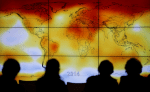 Participants look at a screen showing a world map depicting climate anomalies during the World Climate Change Conference at Le Bourge, France, in December 2015. File photo: CNS/Reuters