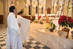 Father Yim incensing the picture of late Bishop Michael Yeung.