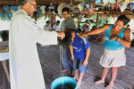 Augustinian Father Miguel Angel Cadenas baptises a young man in a village along the Urituyacu River in Peru. File photo: CNS