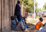 Relatives of victims of an attack wait outside a morgue in Ouagadougou, Burkina Faso. Photo: CNS/Reuters