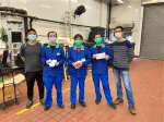 Cleaning workers at a refuse collection point receiving face masks from the labour commission.