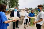 Father Francis Xavier Nguyen Duc Dai of Son Loi, Vietnam, distributes food to local people while wearing a protective mask. The area has been quarantined due to the Covid-19 coronavirus. Photo: CNS/Reuters