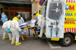 Members of Madrid's Emergency Service, in protective equipment, transfer a patient to another hospital on April 20, during the Covid-19 pandemic. Photo: CNS/Reuters