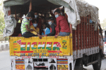 Migrant workers from Bihar take a truck to cross the Delhi-Uttar Pradesh state border at Ghazipur on May 16 to return to their homes. Photo: UCAN/Bijay Kumar Minj