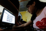 A depiction of a teenager looking over her Facebook page. The Internet facilitates sexual exploitation of children. File photo: CNS/Reuters