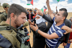 Palestinians argue with Israeli soldiers during a June 19 protest near Hebron, West Bank. Photo: CNS/Reuters