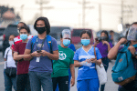 Workers wear facemasks wait for shuttle services in Manila, Philippines, on August 4, the first day of the government's reimplementation of a stricter pandemic lockdown. Photo: CNS/Reuters