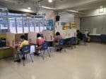 People eating on partitioned tables inside the Caritas Community Centre in Caine Road on July 29.