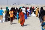 People who fled the Islamic State receive aid at a camp for displaced people in Daquq, Iraq in 2016. Photo: CNS/Reuters