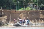 Locals gather sandbags to protect their area from erosion in Kamarkhali village. Photo: UCAN/Caritas Bangladesh