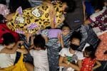 A family sleeps inside a modular tent at an evacuation centre in Manila, Philippines, where residents from low-lying areas took shelter on November 2 in the aftermath of Super Typhoon Goni, locally known as Rolly. Photo: CNS/euters