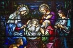 The stained-glass window at St. Aloysius Church in Great Neck, New York, depicting Jesus in the manger surrounded by Mary, Joseph and three shepherds. Photo: CNS
