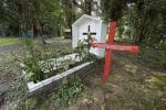 The grave of US-born Maryknoll Sister Dorothy Stang in Anapu, Brazil. She was assassinated in 2005. The red cross beside her grave bears the names of 16 local rights activists who have been murdered since her killing. Photo: CNS