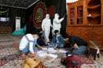 Workers disinfect the interior of a mosque as students, wearing masks, continue to study in the holy city of Najaf, Iraq. Photo: CNS/Reuters