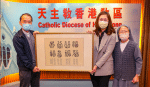 Father Benedict Lam presenting an artwork by Sister Laura Watt Shuk-mee to a buyer on February 6.