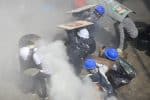 Protesters take shelter behind shields as they clash with riot police officers in Yangon, Myanmar, on March 1. Photo: CNS/Reuters