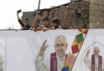 Children look over an image of Pope Francis during his visit with the community at the Church of the Immaculate Conception in Qaraqosh, Iraq, on March 7. Photo: CNS