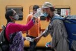 A health worker checks a passenger’s temperature and pulse at a railway station platform in Mumbai, India, on April 7. Photo: CNS/Reuters