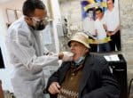 Dr. Haddad attends a patient in his flat at the Haifa Home for Holocaust Survivors in Israel Photo: CNS