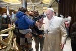 Pope Francis greeting a child as he visits people who came to the Vatican for the second dose of their Covid-19 vaccinations in the Paul VI hall at the Vatican on April 23. Photo: CNS/Vatican Media