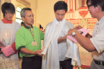 Nicholas Chan, serves as a godfather during a baptism Mass marking the 120th anniversary of the establishment of St. Joseph’s Chapel in 2011.