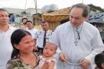 Bishop David visiting residents of a mission station in the Diocese of Kalookan. File photo: UCAN