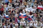 Pilgrims hold up the Slovak flag in St. Peter’s Square as Pope Francis announces he will visit their country on July 4. Photo: CNS/Vatican Media