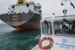 The boat of the Mission to Seafarers, right, delivering supplies to sailors stranded on visiting cargo vessels in Hong Kong. Photo: CNS/Lam Yik, Reuters