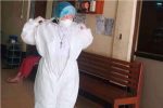 Sister Nu Tawng puts on personal protective equipment at a church-run Covid-19 care centre in Myitkyina.