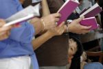 A boy attends Mass with his family at the Church of Ss. Peter and Paul in Singapore in 2010. Photo: CNS/May Naji, Reuters