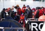 Migrants are escorted by military personnel after being rescued while crossing the English Channel in Dover, England, May 1, 2022. English and Welsh bishops said the U.K. government is unfairly punishing the migrants for the crimes of trafficking gangs by sending the them to Rwanda to have their asylum applications processed. (CNS photo/Henry Nicholls, Reuters)