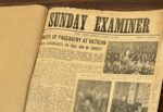 Vintage newspaper opened to the bold masthead 'SUNDAY EXAMINER' on a yellowed page with photos and text blocks nearby.